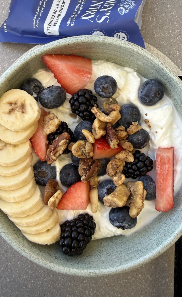 Yogurt bowl with Cinnamon Almond Butter granola, fresh berries, and sliced banana