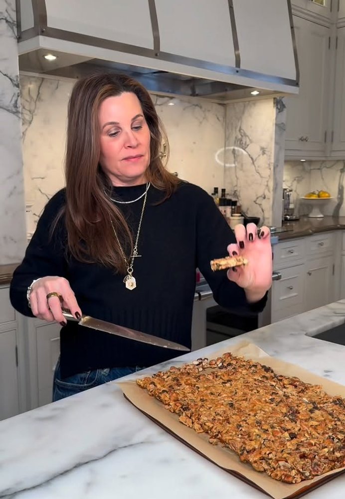 Haley slicing a fresh batch of granola in her kitchen